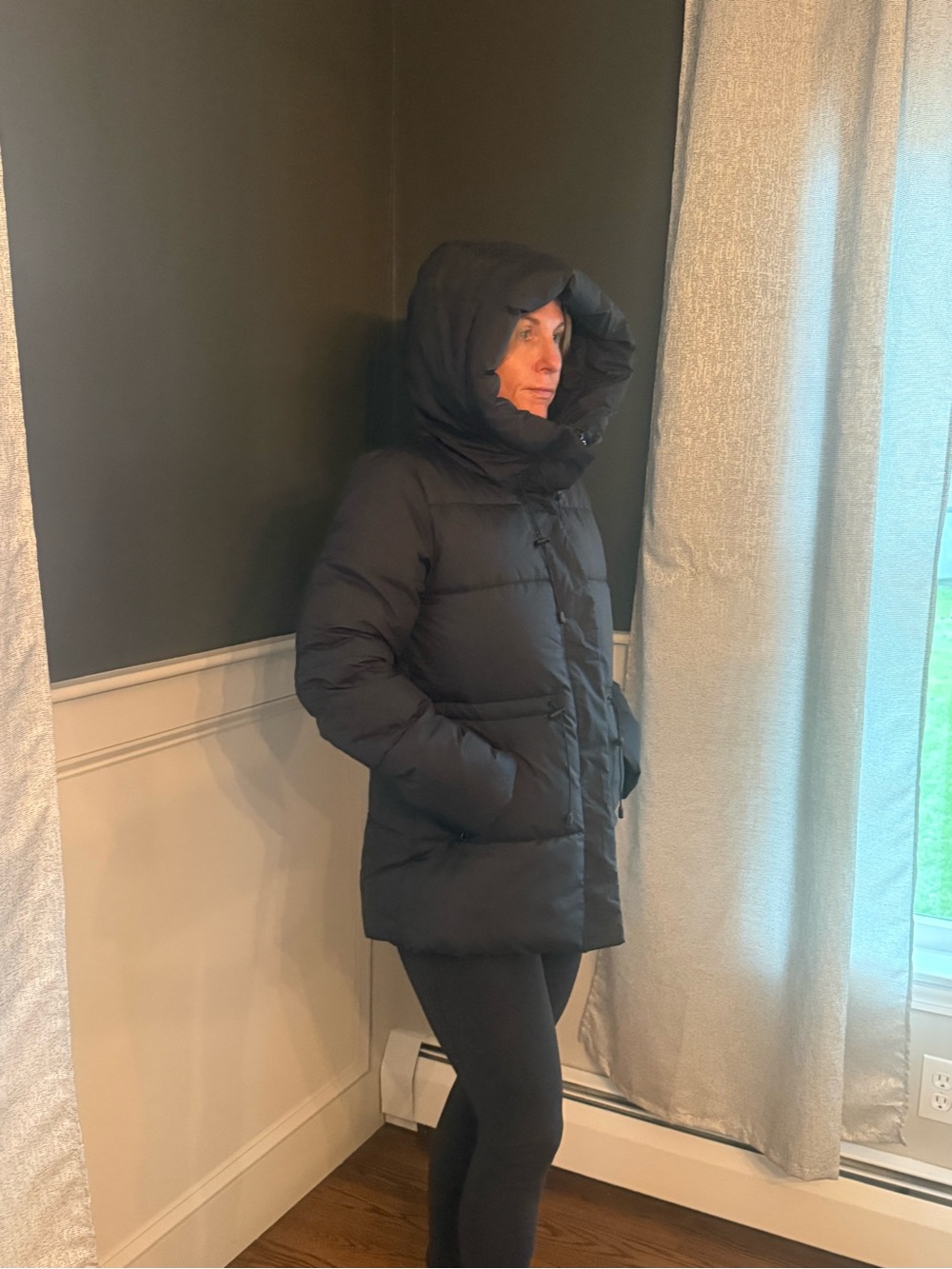 Black women’s winter puffer coat with extra large hood and face guard.